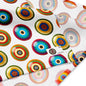 A close-up of bandana featuring a coluorful repeating pattern of concentric target circles. A small fabric tag is visible on the right side.