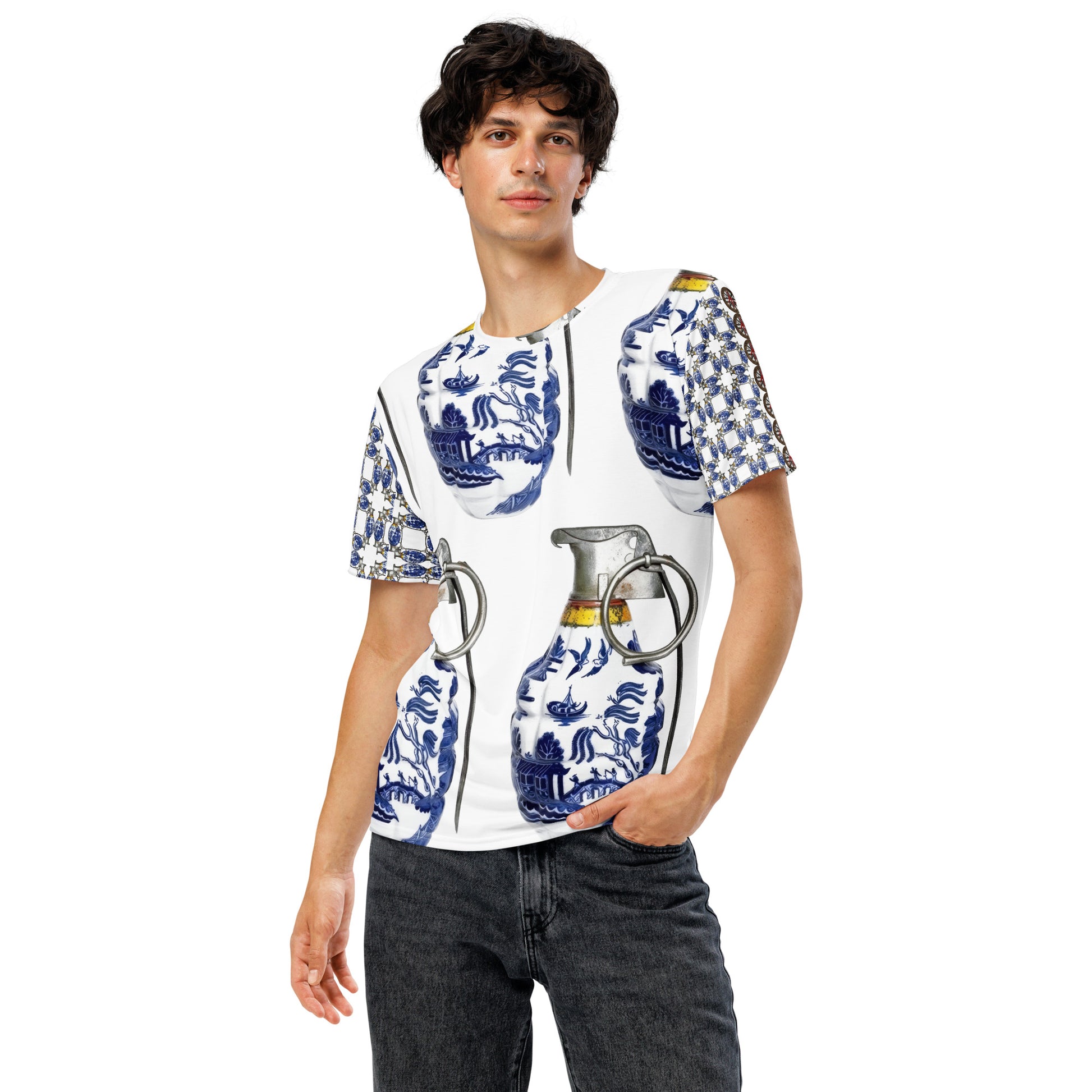 A man modeling a white short-sleeve t-shirt with a blue and white porcelain-style grenade print featuring large grenade motifs, paired with dark gray jeans against a plain white background.