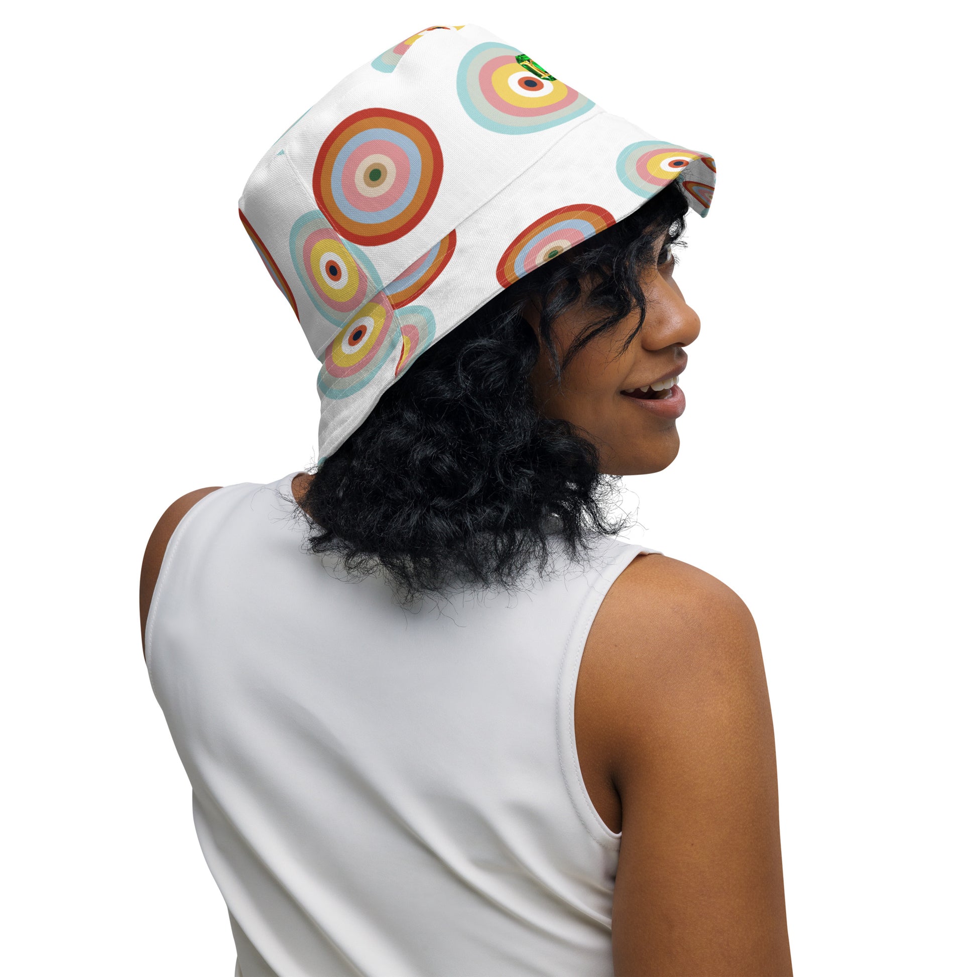 Person wearing a colorful bucket hat with a white background