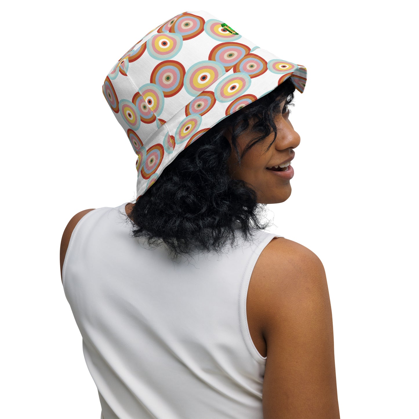 Person wearing a colorful bucket hat on a white background