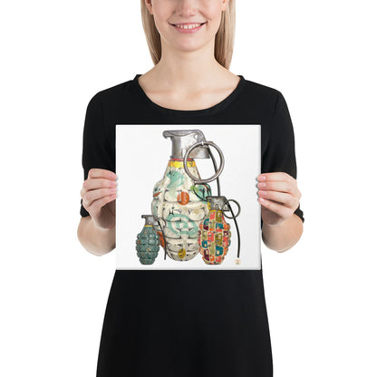A woman wearing a black t-shirt holds up a square print featuring a colorful graphic illustration of three hand grenades with mid-century wallpaper designs on them on a white background.