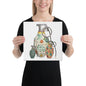 A woman holding a square art print featuring three illustrated hand grenades with colorful mid-century patterns and metallic details on a white background.